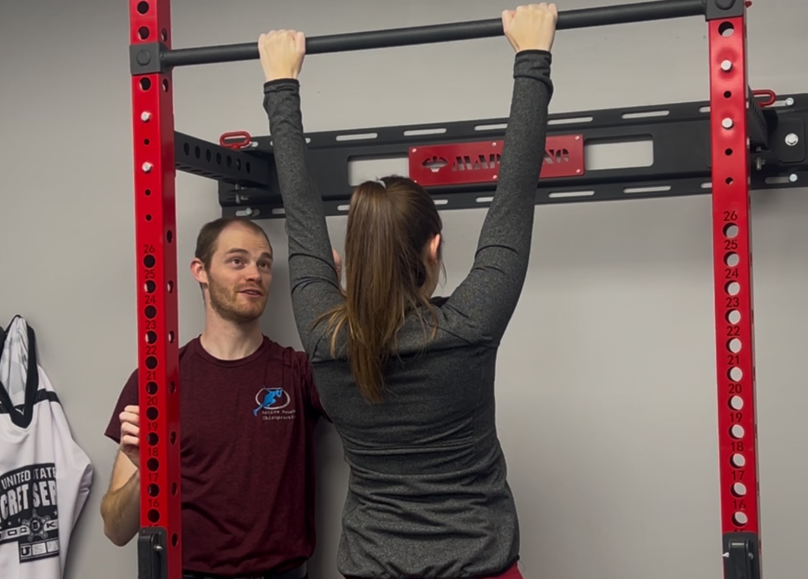 Patient performing constraint-based rehabilitation at Active Rehab Chiropractic